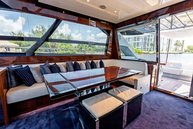 Knot Normal Yacht Photos Pics Luxurious interior of 2020 Riva 66' Ribelle yacht with plush seating and large windows.