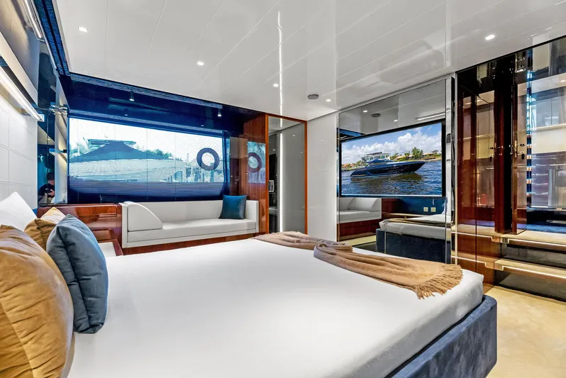 Knot Normal Yacht Photos Pics Luxurious bedroom interior of 2020 Riva 66' Ribelle yacht with modern decor and large windows.