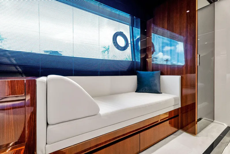 Knot Normal Yacht Photos Pics Luxurious interior of 2020 Riva 66' Ribelle yacht with white sofa and blue pillow.
