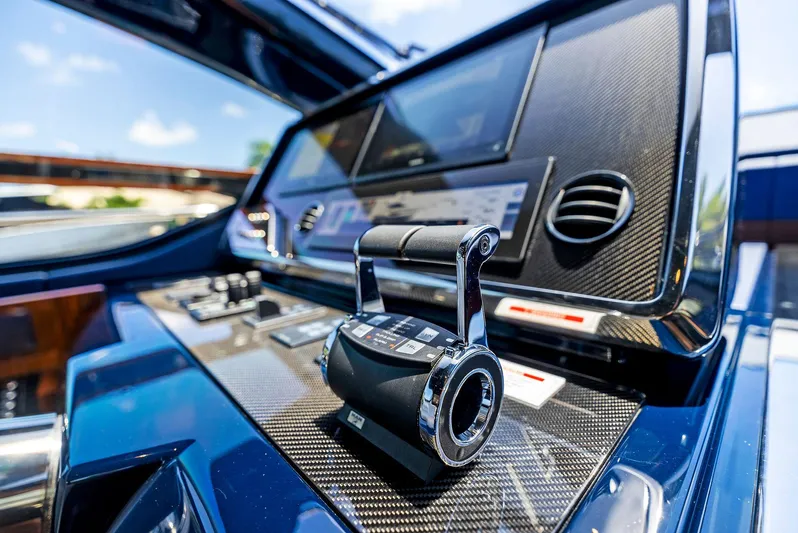 Knot Normal Yacht Photos Pics Control panel of 2020 Riva 66' Ribelle yacht with throttle lever and navigation screens.