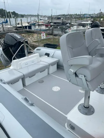  Yacht Photos Pics 2023 Protector 250 Chase boat interior with seating, docked at marina.
