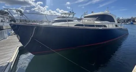 True Story Yacht Photos Pics 2006 Mochi Craft 51' Dolphin yacht docked in a sunny marina.