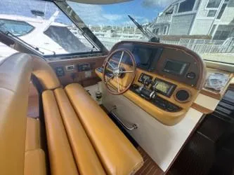 True Story Yacht Photos Pics Interior helm of 2006 Mochi Craft 51' Dolphin yacht with tan leather seating.