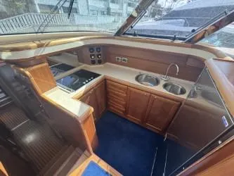 True Story Yacht Photos Pics Interior of 2006 Mochi Craft 51' Dolphin yacht, featuring a modern kitchen with wood cabinetry.