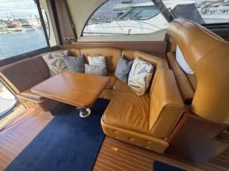 True Story Yacht Photos Pics Luxurious interior of 2006 Mochi Craft 51' Dolphin yacht with leather seating and cushions.