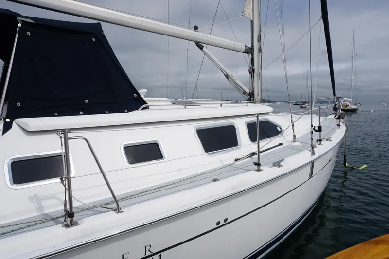  Yacht Photos Pics 2006 Hunter 41 Deck Salon sailboat on calm water, showcasing sleek design and modern features.