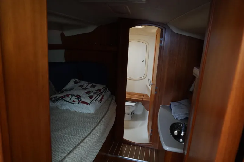  Yacht Photos Pics Interior of 2006 Hunter 41 Deck Salon with cozy bed and compact bathroom.