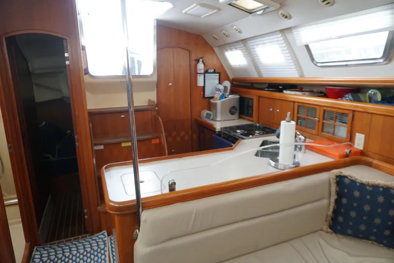  Yacht Photos Pics Interior of 2006 Hunter 41 Deck Salon yacht with kitchen and seating area.