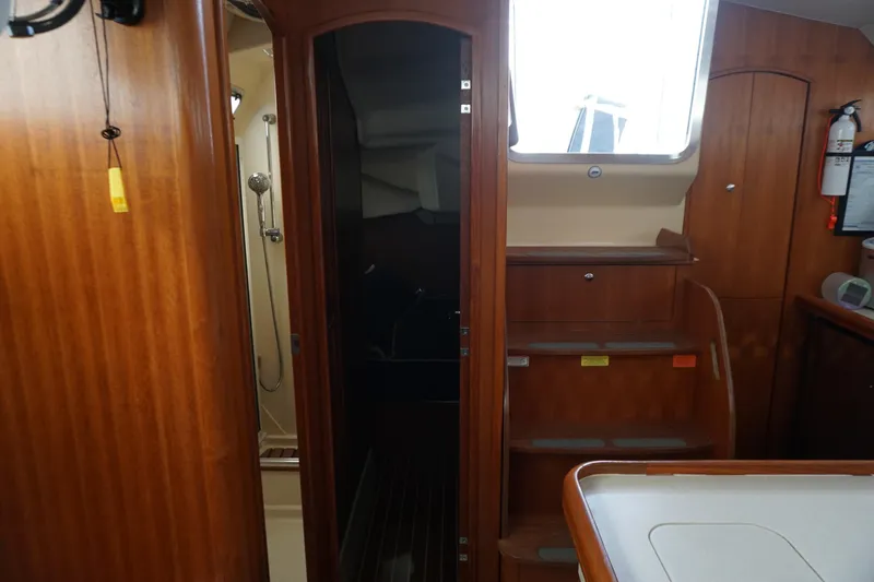 Yacht Photos Pics Interior of 2006 Hunter 41 Deck Salon yacht with wooden cabinetry and stairs.