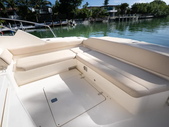 "nameless" Yacht Photos Pics 2014 Pursuit SC 365i Sport Coupe interior with beige seating by the water.