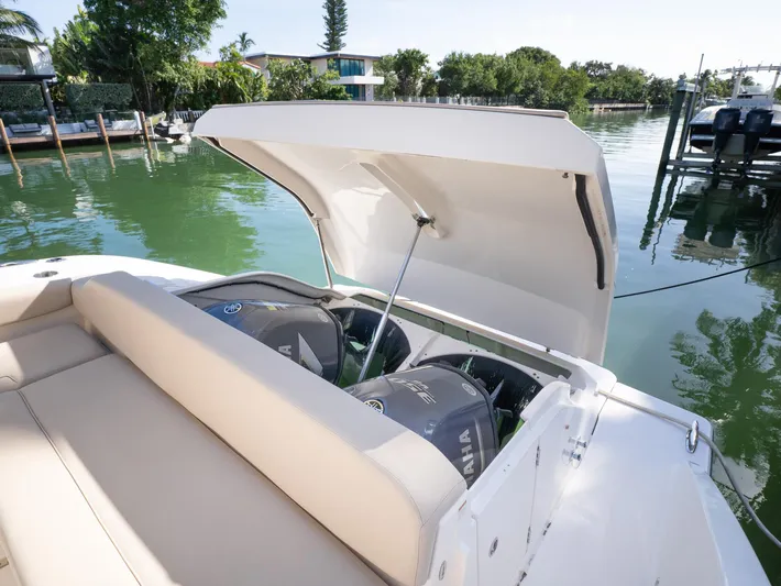"nameless" Yacht Photos Pics 2014 Pursuit SC 365i Sport Coupe with open engine compartment by the water.