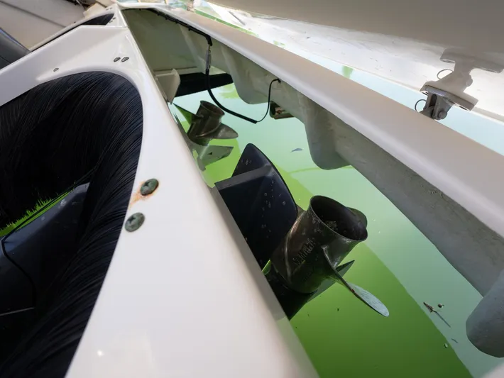"nameless" Yacht Photos Pics 2014 Pursuit SC 365i Sport Coupe propeller in water, close-up view.