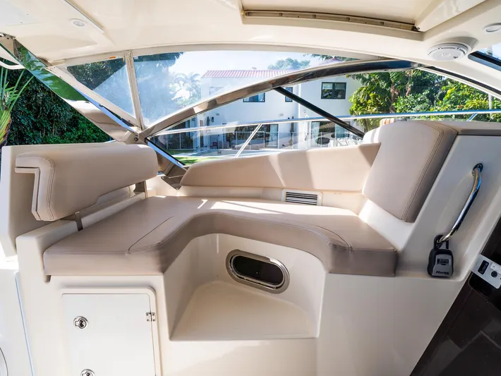 "nameless" Yacht Photos Pics Luxurious interior of 2014 Pursuit SC 365i Sport Coupe with beige seating and modern design.