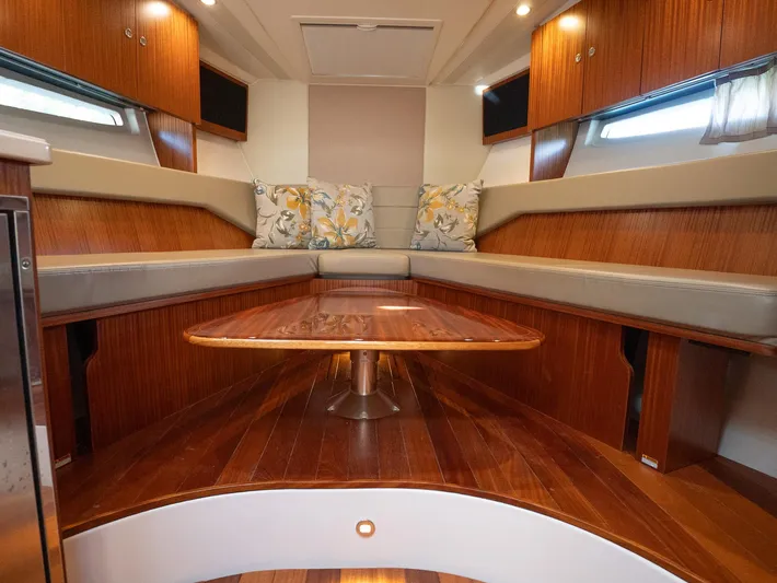 "nameless" Yacht Photos Pics Luxurious interior of 2014 Pursuit SC 365i Sport Coupe with wood finishes and seating.
