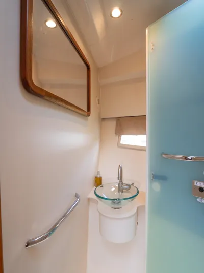 "nameless" Yacht Photos Pics 2014 Pursuit SC 365i Sport Coupe bathroom with glass sink and modern fixtures.