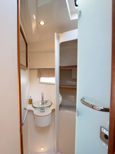 "nameless" Yacht Photos Pics 2014 Pursuit SC 365i Sport Coupe bathroom with modern sink and storage shelves.
