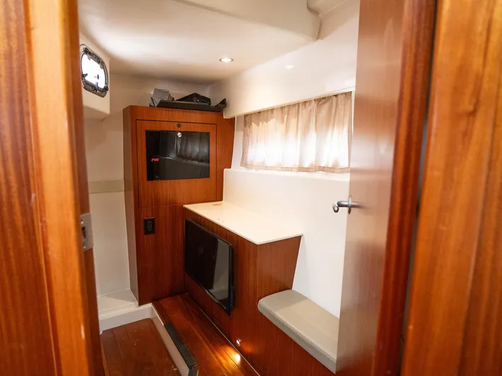 "nameless" Yacht Photos Pics Interior cabin of 2014 Pursuit SC 365i Sport Coupe with wood finish and seating.