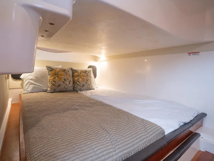 "nameless" Yacht Photos Pics 2014 Pursuit SC 365i Sport Coupe cabin with cozy bed and floral pillows.