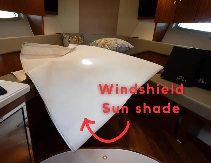 "nameless" Yacht Photos Pics 2014 Pursuit SC 365i Sport Coupe interior with windshield sun shade displayed.