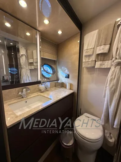 Yacht Photos Pics Luxurious bathroom in 2019 Azimut Fly 72 yacht with elegant fixtures and porthole window.