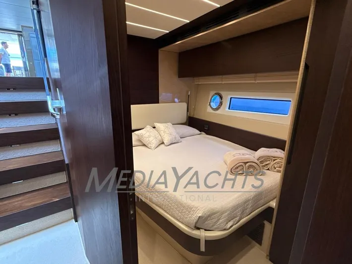  Yacht Photos Pics Luxurious bedroom interior on 2019 Azimut Fly 72 yacht with elegant bedding and porthole window.