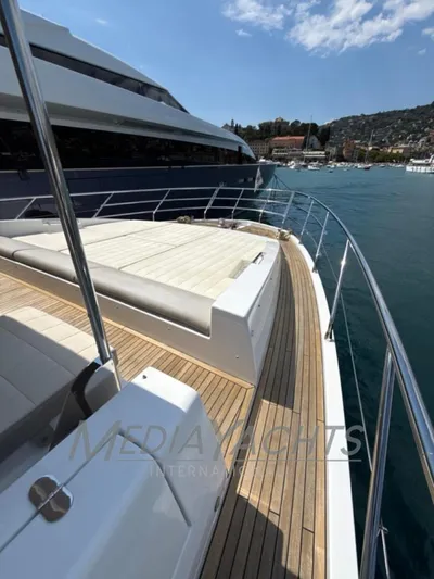  Yacht Photos Pics Luxurious 2019 Azimut Fly 72 yacht deck with sunbathing area, docked in scenic harbor.