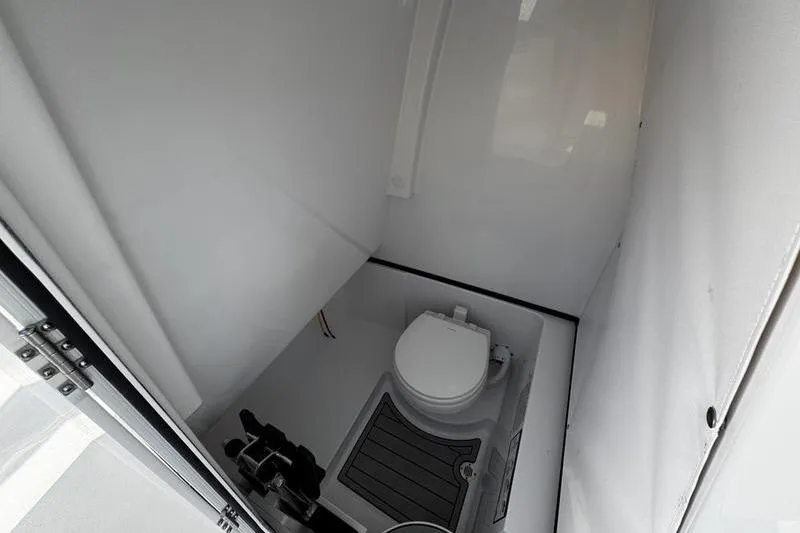  Yacht Photos Pics 2026 Sportsman Heritage 261 Center Console boat interior with compact marine toilet.