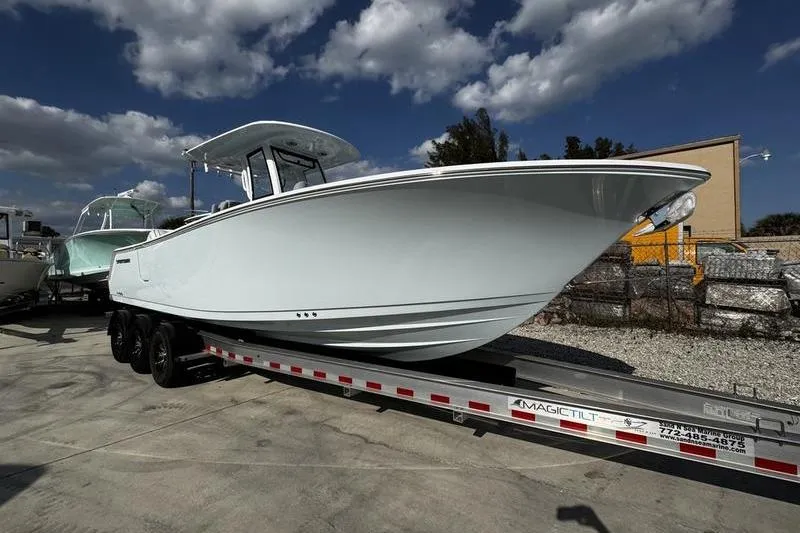  Yacht Photos Pics 2026 Sportsman Heritage 261 Center Console boat on trailer under cloudy sky.