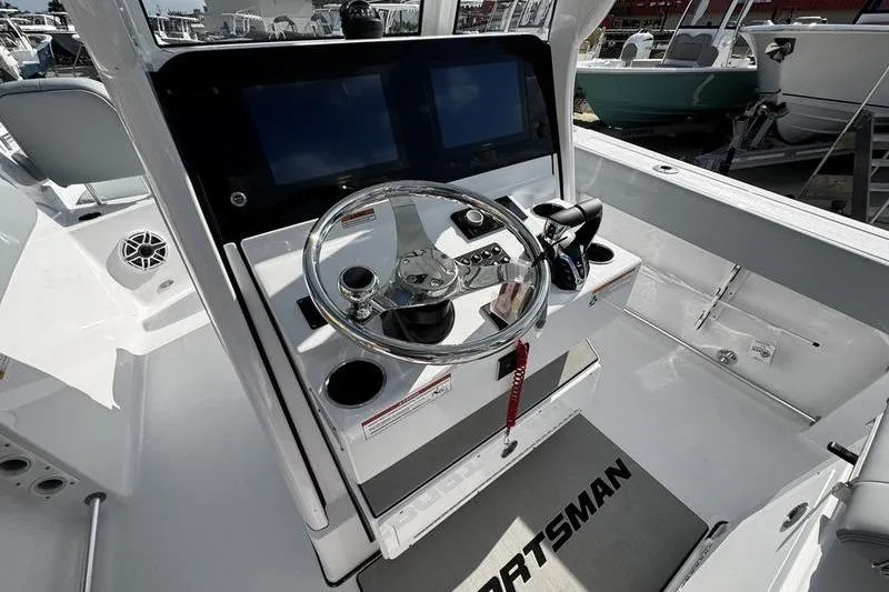  Yacht Photos Pics 2026 Sportsman Heritage 261 Center Console boat dashboard with steering wheel and dual screens.
