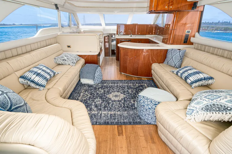 Blue Nomad Yacht Photos Pics Luxurious interior of 2001 Sea Ray 560 Sedan Bridge yacht with plush seating and elegant decor.