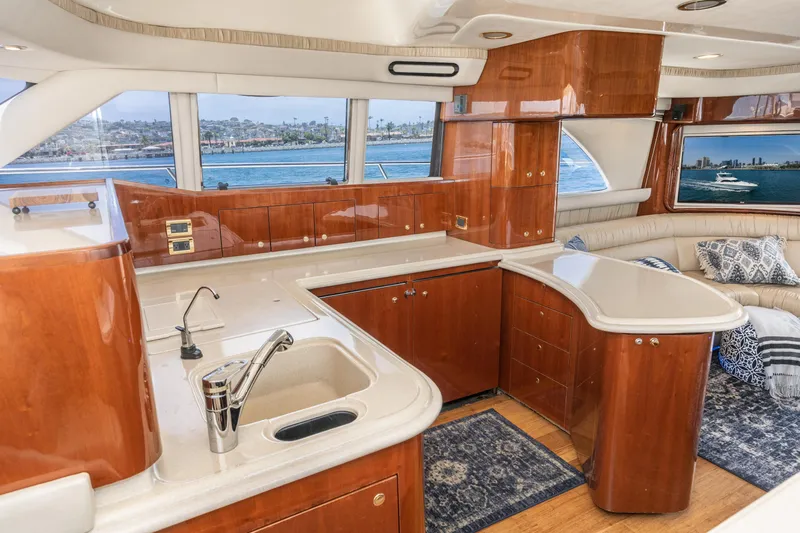 Blue Nomad Yacht Photos Pics Luxurious interior of 2001 Sea Ray 560 Sedan Bridge yacht with elegant wood finishes.