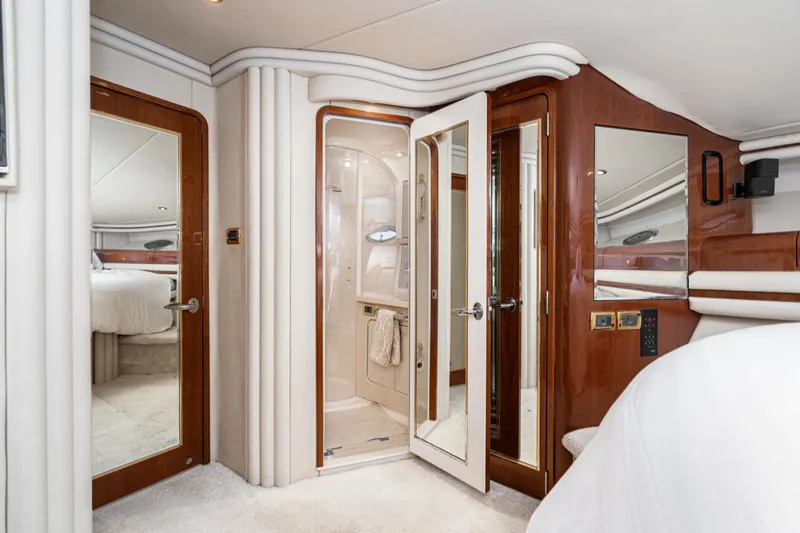 Blue Nomad Yacht Photos Pics Luxurious interior of 2001 Sea Ray 560 Sedan Bridge yacht with elegant wood finishes.