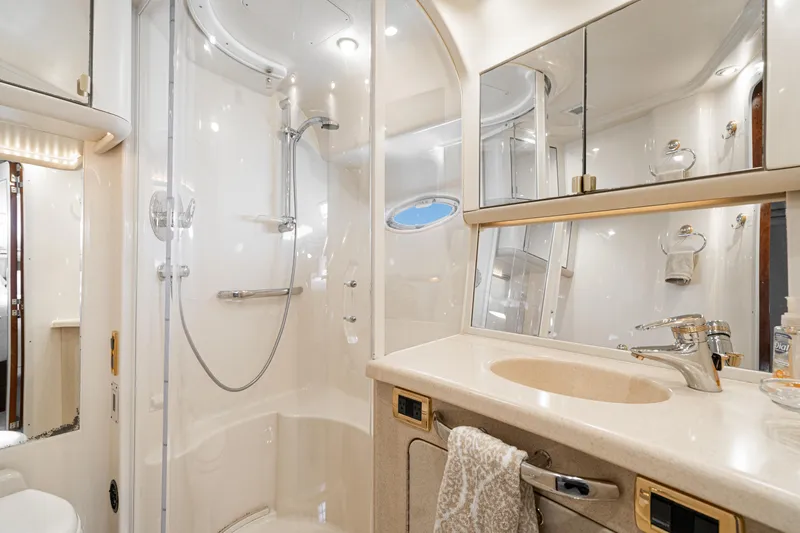 Blue Nomad Yacht Photos Pics Luxurious bathroom in 2001 Sea Ray 560 Sedan Bridge yacht with shower and vanity.