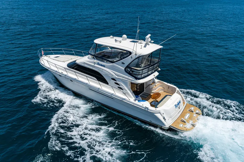 Blue Nomad Yacht Photos Pics 2001 Sea Ray 560 Sedan Bridge yacht cruising on open blue waters.