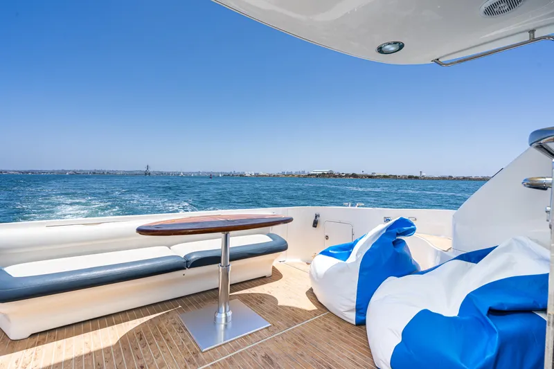 Blue Nomad Yacht Photos Pics Luxurious 2001 Sea Ray 560 Sedan Bridge yacht deck with ocean view and seating.