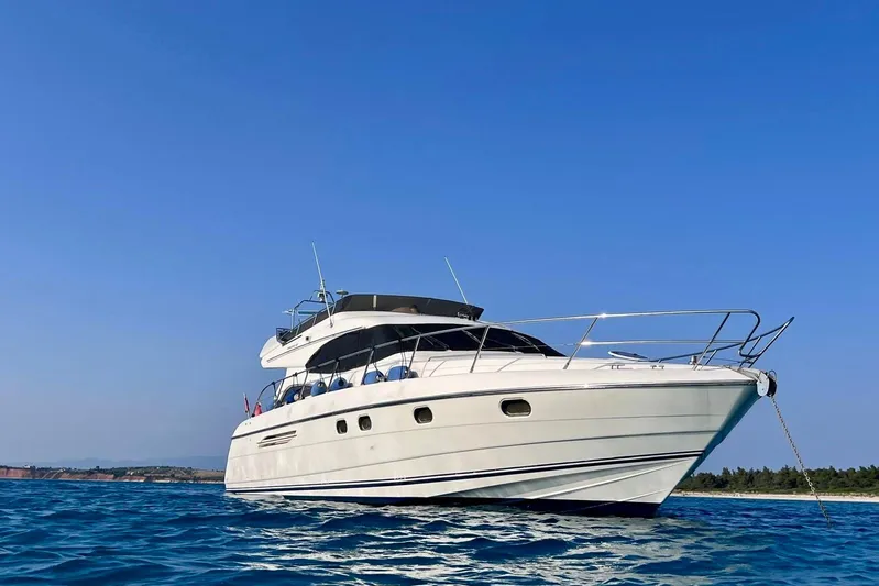  Yacht Photos Pics Luxury Princess 56 yacht from 2000 on clear blue water under sunny sky.