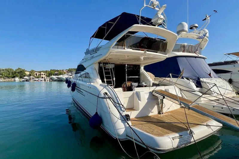  Yacht Photos Pics Luxury yacht Princess 56, 2000 model, docked in a serene marina setting.
