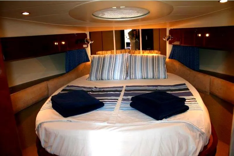  Yacht Photos Pics Luxurious cabin interior of a 2000 Princess 56 yacht with a cozy bed.