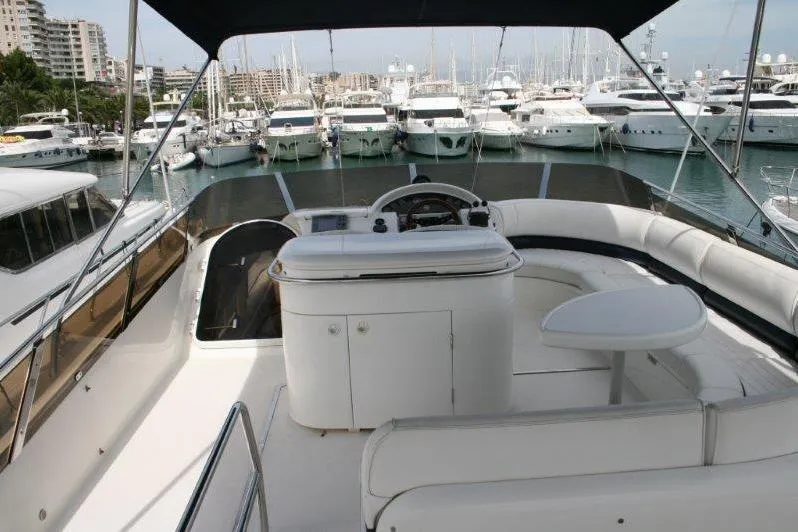  Yacht Photos Pics Luxury yacht Princess 56, 2000 model, docked in a marina with multiple boats.