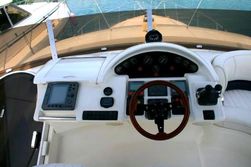  Yacht Photos Pics Cockpit of a 2000 Princess 56 yacht with steering wheel and navigation controls.