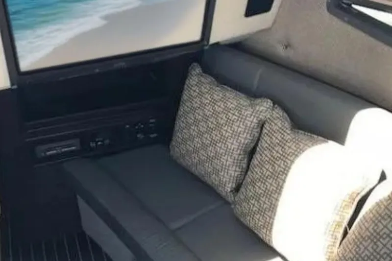 Yacht Photos Pics Interior of 2018 Cobalt R35 boat with cushioned seating and beach scene on screen.