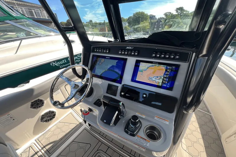  Yacht Photos Pics 2024 Boston Whaler 280 Outrage helm with dual navigation screens and steering wheel.