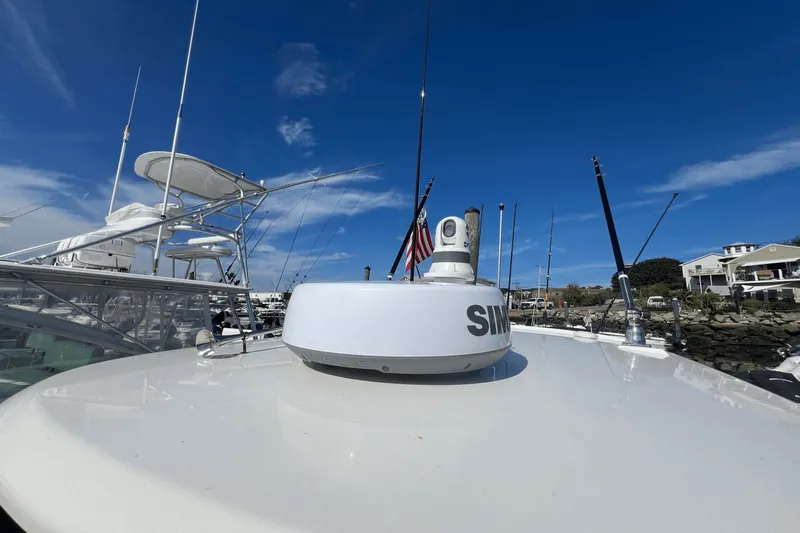  Yacht Photos Pics 2024 Boston Whaler 280 Outrage boat with radar, docked under clear blue sky.