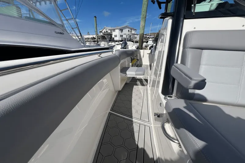  Yacht Photos Pics 2024 Boston Whaler 280 Outrage boat interior with gray seating and hexagonal flooring.