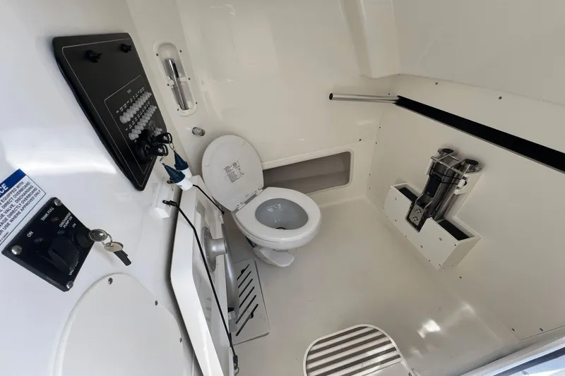  Yacht Photos Pics 2024 Boston Whaler 280 Outrage boat interior with toilet and control panel.