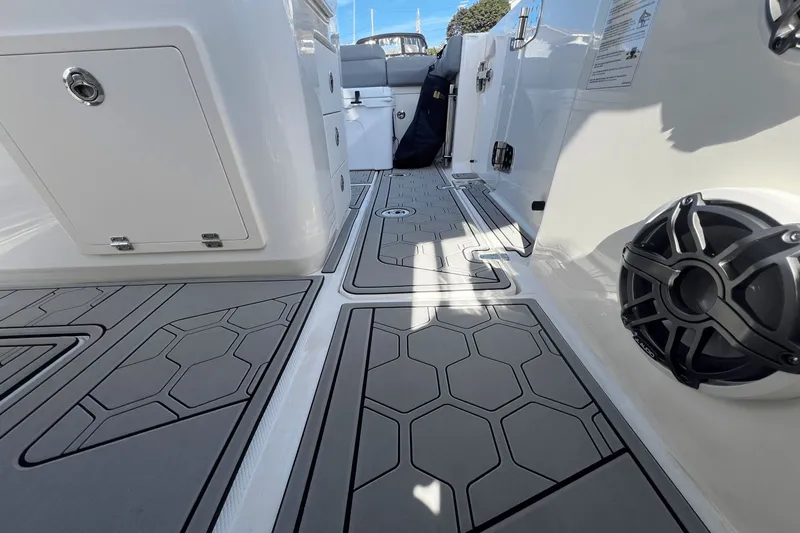  Yacht Photos Pics 2024 Boston Whaler 280 Outrage interior with hexagonal-patterned flooring and speaker.
