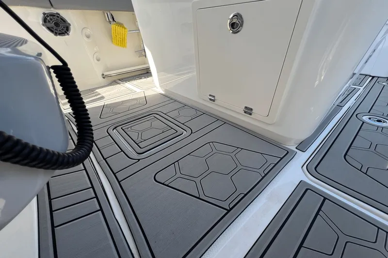  Yacht Photos Pics 2024 Boston Whaler 280 Outrage deck with textured flooring and storage compartment.