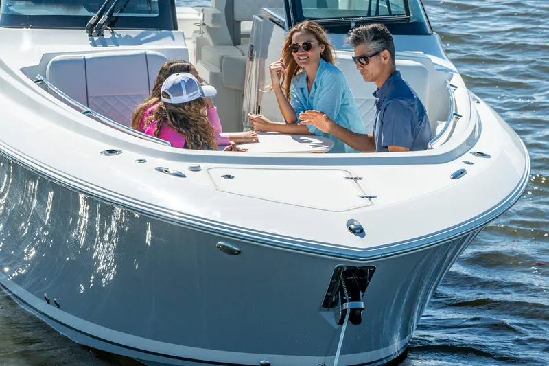  Yacht Photos Pics Manufacturer Provided Image: 2025 Pursuit DC 306 Dual Console boat with people enjoying a sunny day on the water.