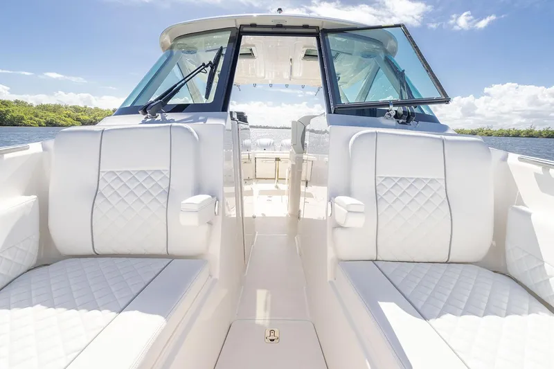  Yacht Photos Pics Manufacturer Provided Image: 2025 Pursuit DC 306 Dual Console boat interior with white seating and open deck.