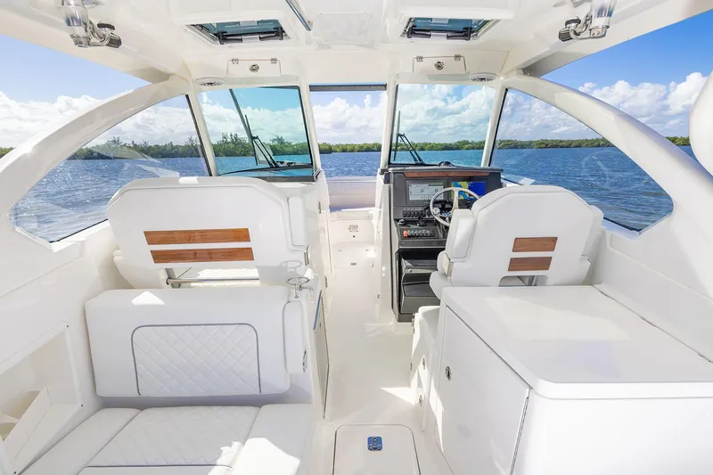  Yacht Photos Pics Manufacturer Provided Image: 2025 Pursuit DC 306 Dual Console boat interior with white seating and scenic water view.